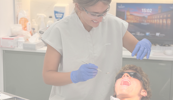 a hygiene therapist and patient smiling during an appointment